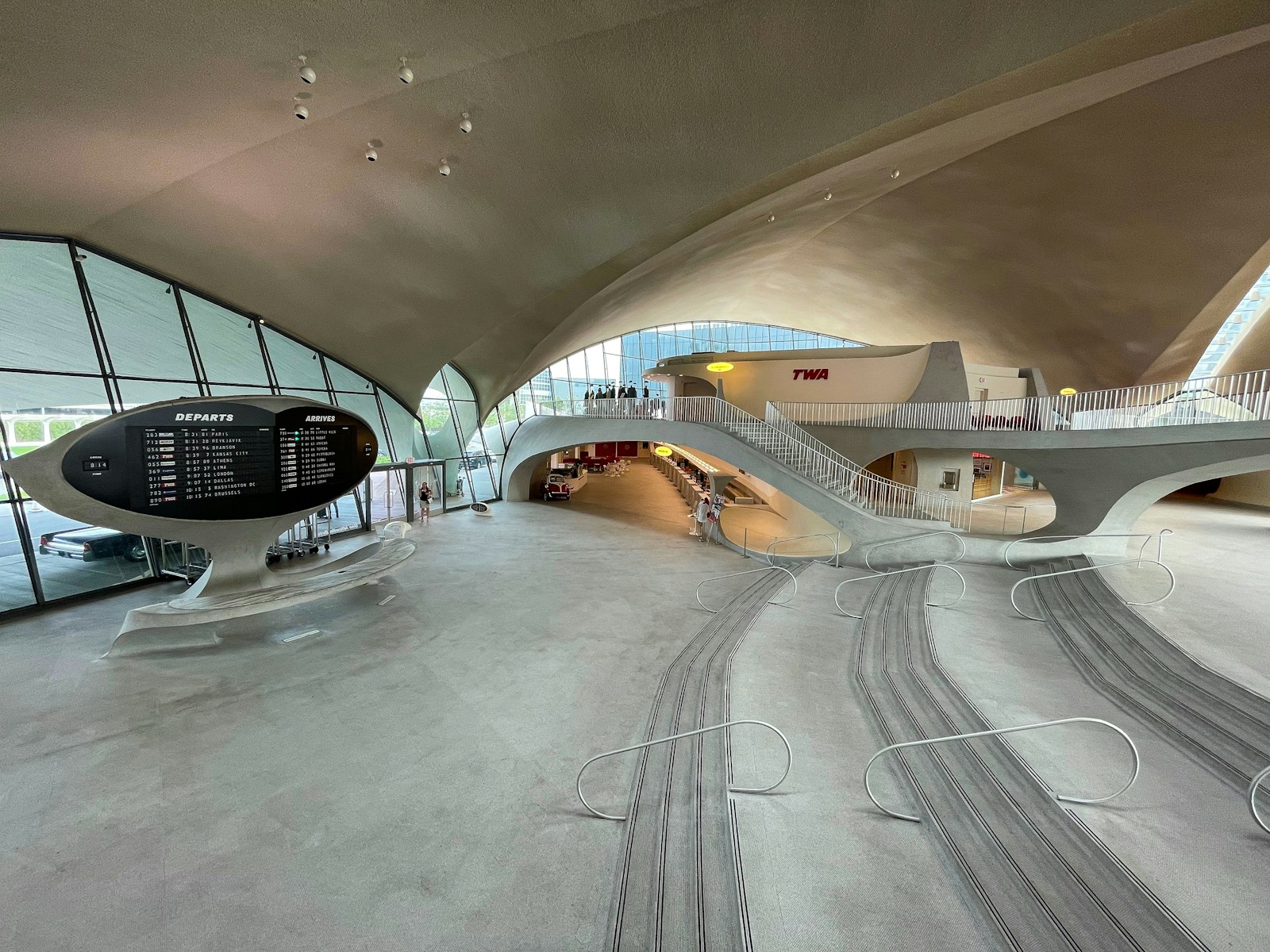 Image source: Unsplash (free-to-use license). Restored TWA Hotel terminal interior at JFK with vintage curved walkway